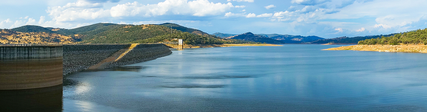 Beautiful panorama landscape of lake and dam surrounded by hills and mountains on sunny day. Wyangala Dam in NSW.