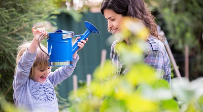 Mother and daughter with watering can.