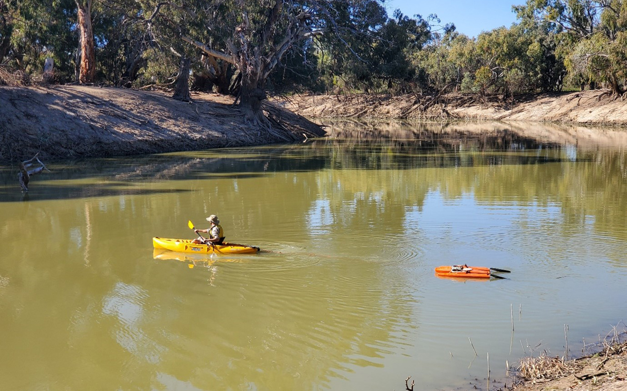 Scientist kayaking on river 