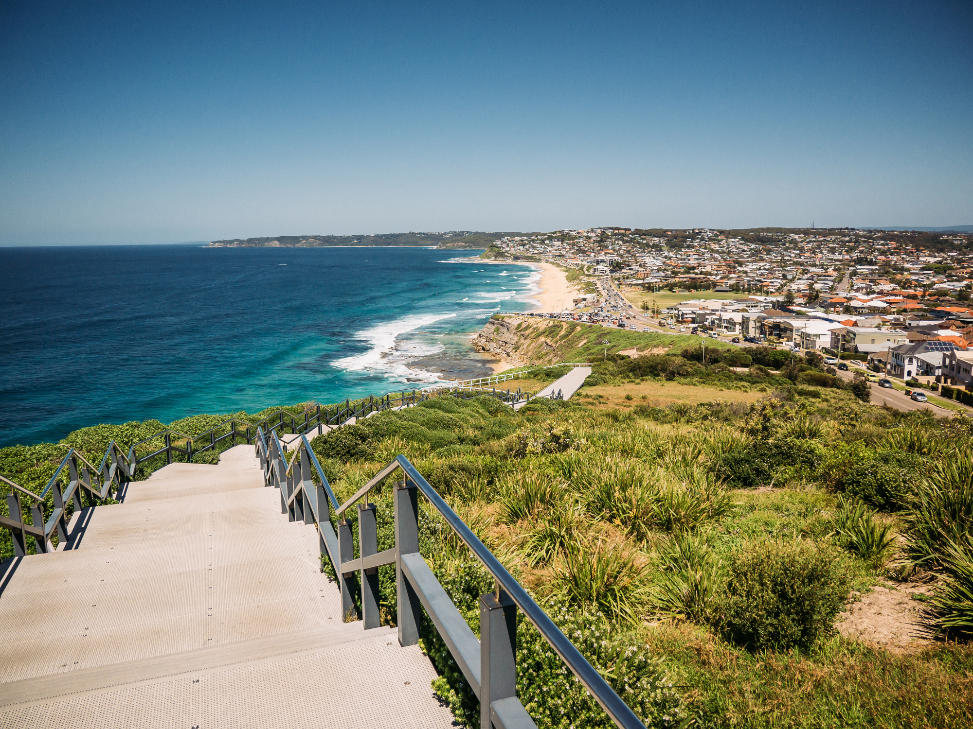 a set of stairs leading down to a beach