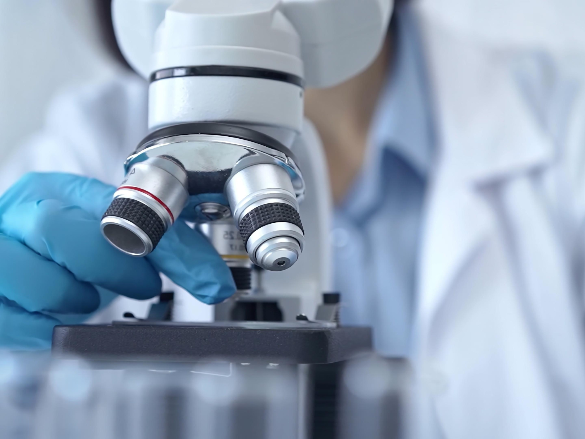a scientist looking in a microscope